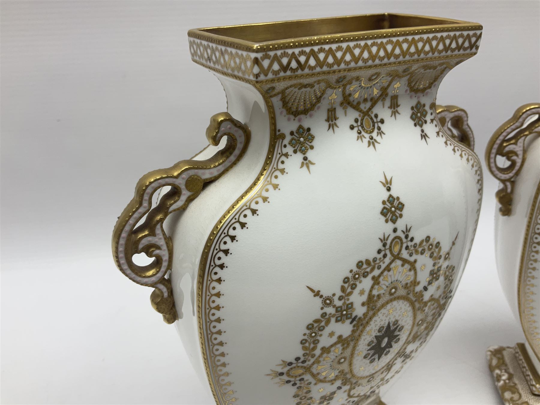 Pair of Copelands enamel jeweled twin handle vases, each decorated with a seated female figures, makers mark beneath, H22cm