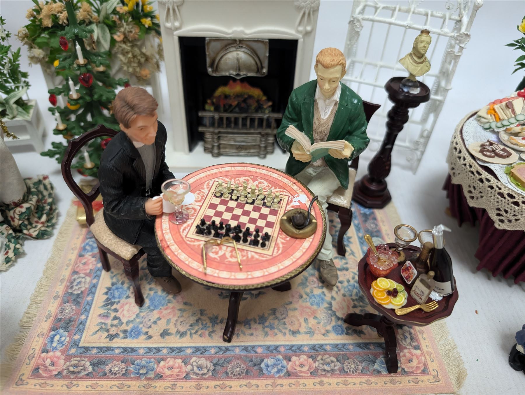 Dolls house furniture, including pianos, fireplace, plants, flower arrangements, tables, chairs, six figures and a collection of instruments and other accessories