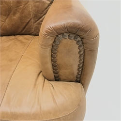 Three seat sofa upholstered in studded tan leather, turned supports (W194cm) and matching two seat sofa (W140cm) and footstool 