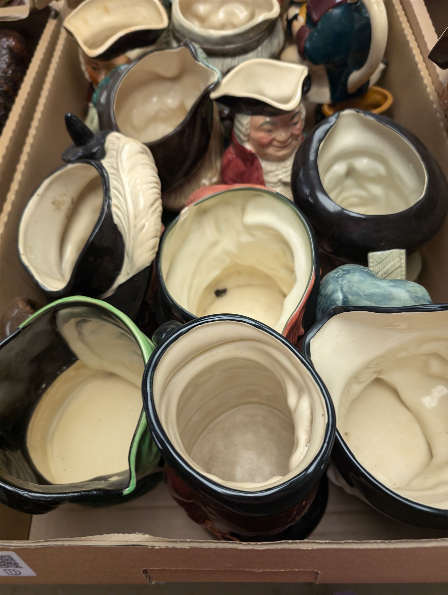 Collection of character and toby jugs and teapots, mostly Royal Doulton examples, in three boxes 
