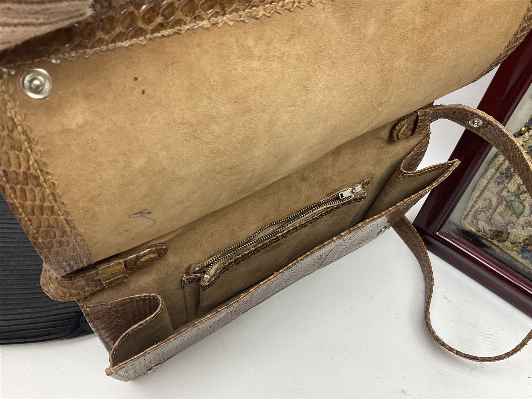 Continental petit point evening bag, with enamel and pearl details, in wooden display frame, together with a snake skin handbag and three other vintage bags