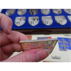 Yorkshire Mint, The Royal Arms Collection, twelve shield shaped silver medallions each depicting variations on the Royal coat of arms, each hallmarked Yorkshire Mint, Birmingham 1976/77, contained within fitted wooden case with associated information cards