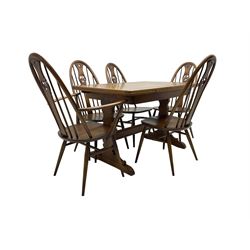 Ercol - elm and beech 'draw-leaf' extending dining table (W114cm D79cm H75cm); and Ercol - set five (4+1) quaker 'Swan' back dining chairs (W50cm D60cm H101cm)
