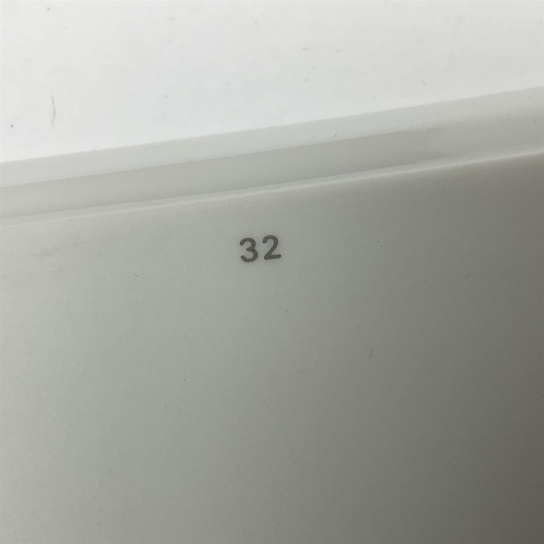 Limoges for Cartier, ceramic trinket dish, of rectangular form with rounded corners, decorated to centre with leopard upon a blue ball, with blue and gilt rim, with printed mark beneath, in original box, H15.5cm, W21cm