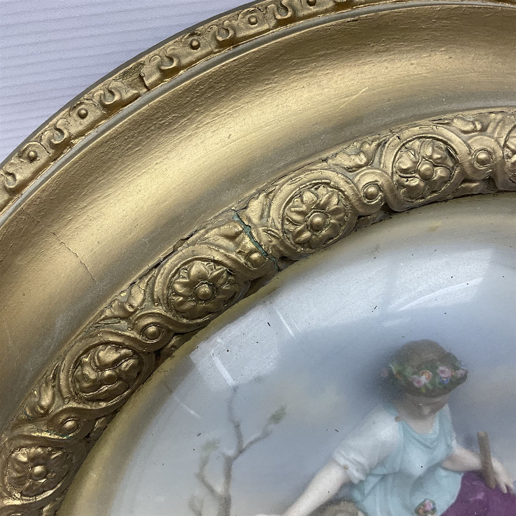 Set of four early 20th century Continental bisque plaques, each of circular form, modelled in high relief as the Four Seasons personified, within gilded circular frames under convex glass, overall D44.5cm