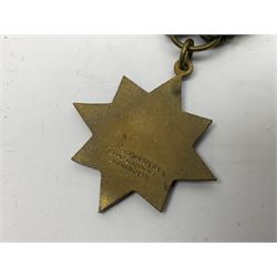 Made-up group of three WWI medals comprising 1914 Star awarded to 23598 Gnr. F. Jefferson R.G.A., British War Medal and Victory Medal with names removed; with ribbons on wearing bar; 1942 Motorist's Medal and small quantity of cap badges, Royalty badges etc