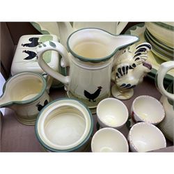 Zeller Fayencerie dinner and tea wares, decorated in cockerels against a yellow ground, with green scalloped border, comprising cake stand, two plates, bowl, three large teacups and saucers, coffee pot, milk jug, cream jug, lidded sugar bowl, pair of cruets modelled as cockerels, butter dish and cover, and utensils pot, and four similar egg cups, in one box 