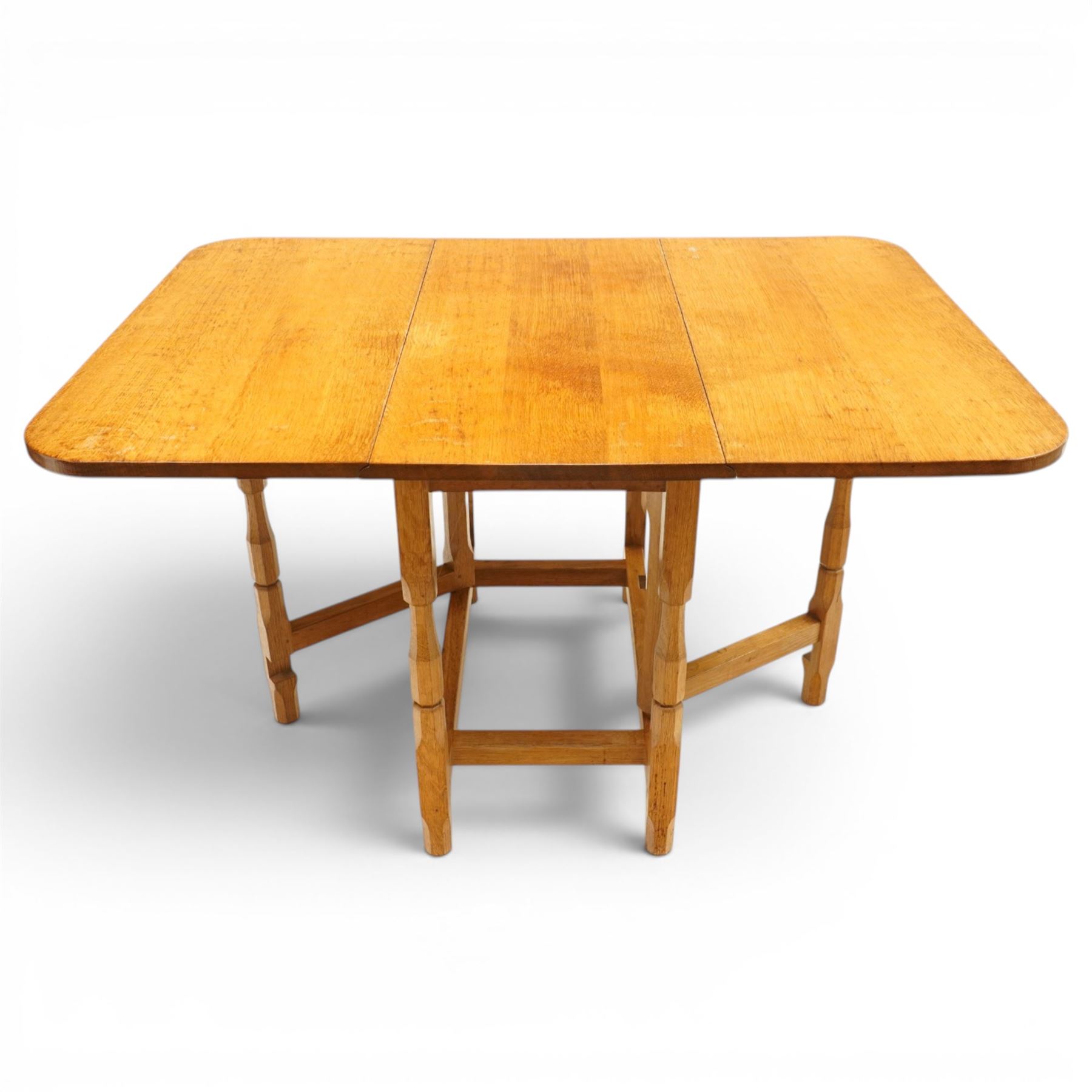 Beaverman - 1980s adzed oak drop-leaf dining table with gate-leg action, adzed top and leaves extending to 129cm, octagonal supports with large Beaver carving, by Colin Almack of Sutton near Thirsk 