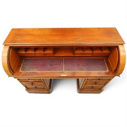 Victorian mahogany twin pedestal cylinder desk, with roll top with fitted interior and with leather writing slide, raised on pedestals with three graduating drawers, raised on a plinth base with castors
