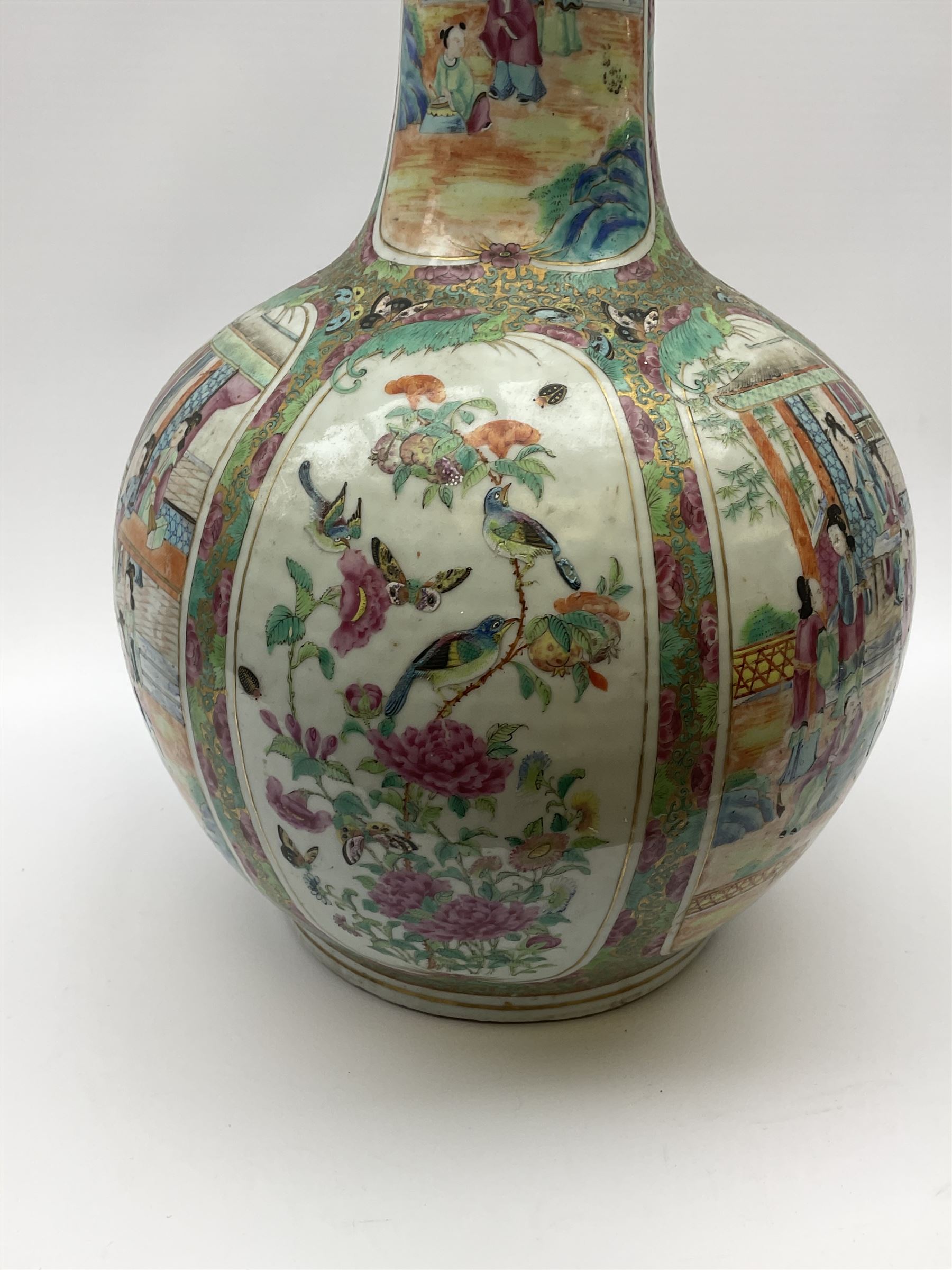A 19th century Chinese Canton Famille Rose vase, of globular form with tall neck, and cover with finial, decorated with alternating panels of figural scenes, and birds and butterflies amongst blossoming and fruiting trees, with foliate surround against gilt, overall H57cm. 