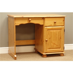  Polished pine single pedestal desk with keyboard slide, drawer and cupboard, on bun feet, W100cm, H77cm, D53cm  