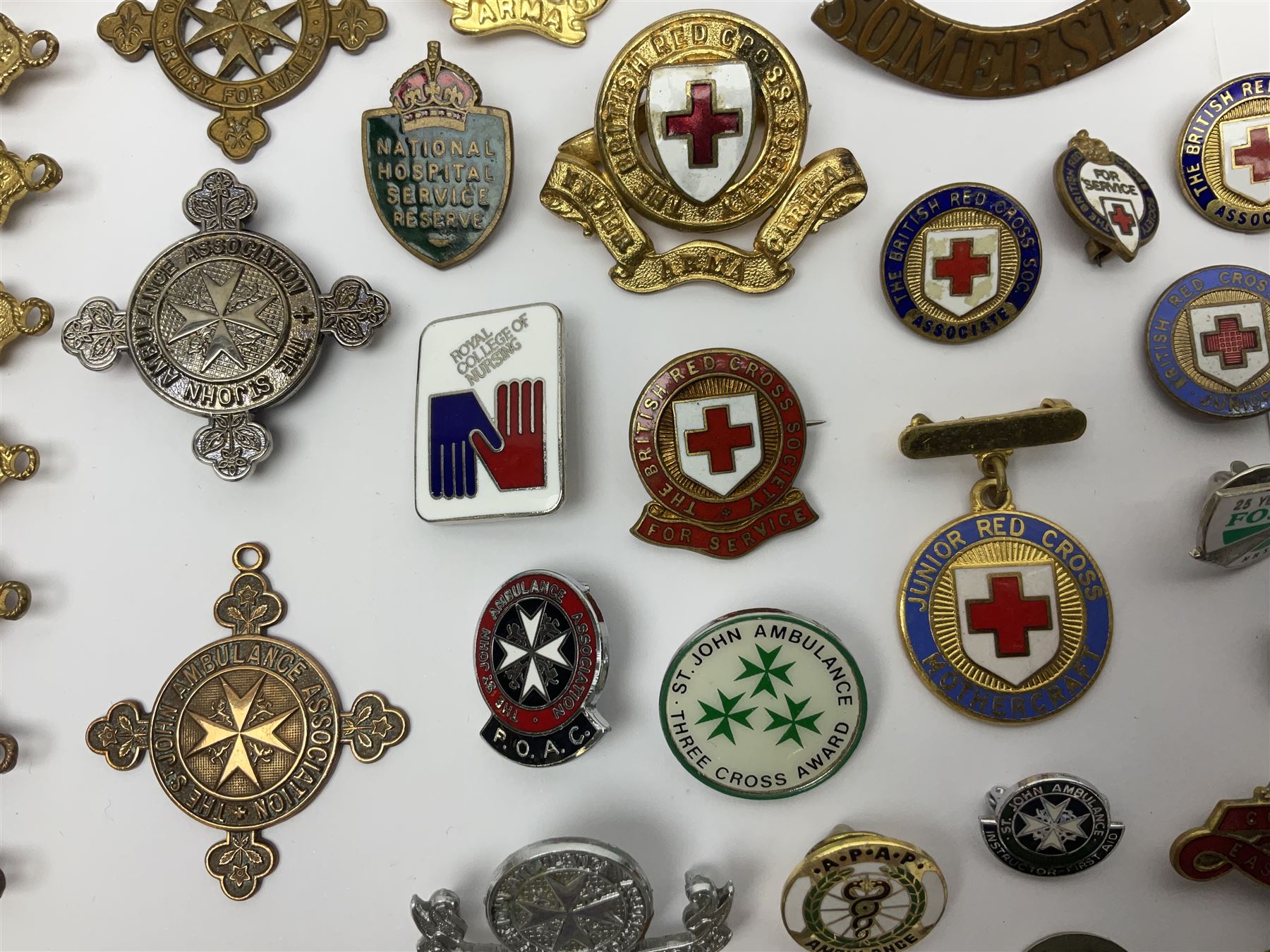 Collection of St John Ambulance enamel and metal badges, together with Red Cross medals and badges