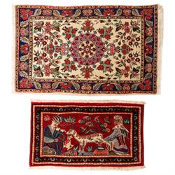 Two small rugs, an ivory ground example decorated with a central floral medallion and scat...