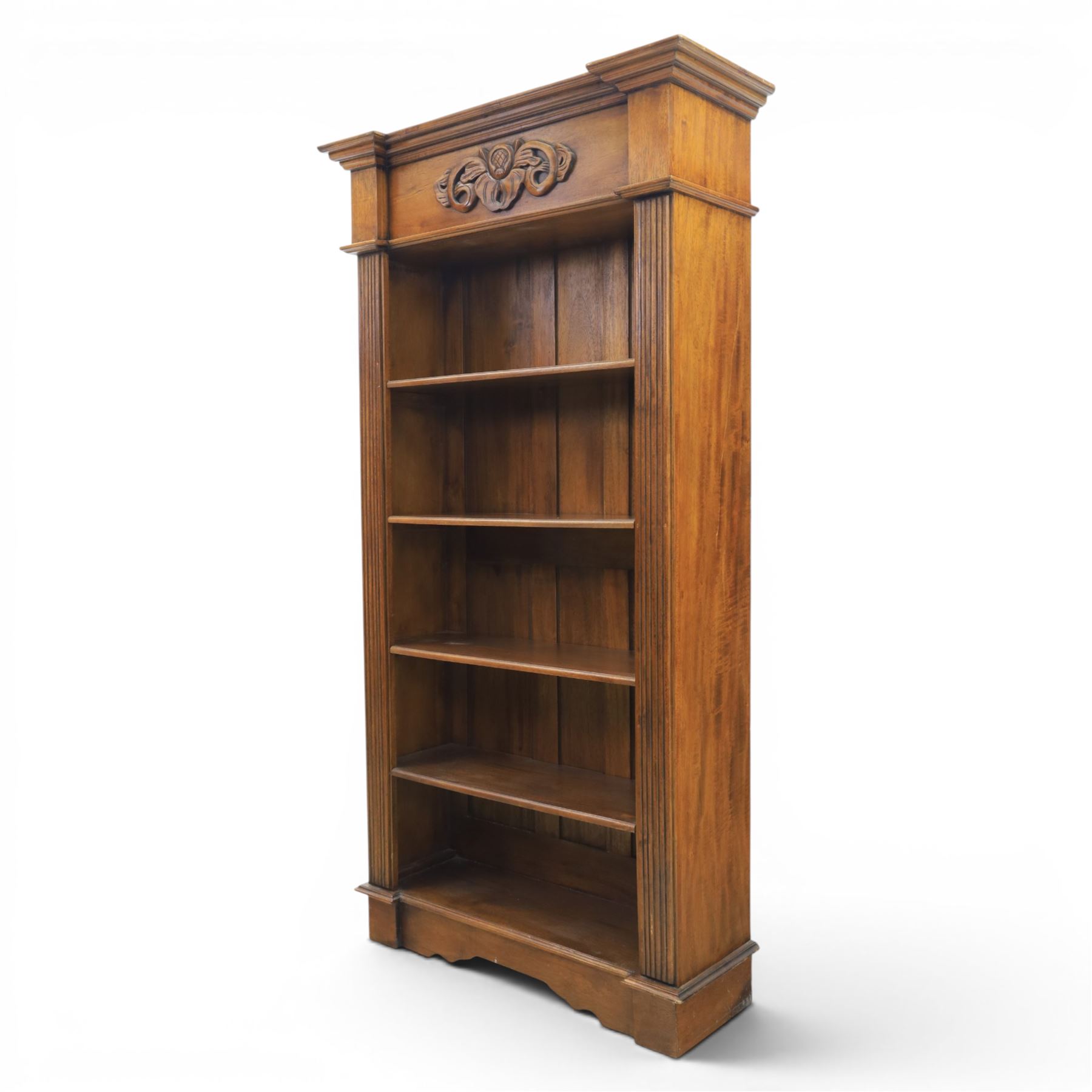 Hardwood open bookcase, fitted with five open shelves, applied carving to top facia