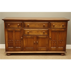  Ercol golden dawn elm sideboard, four drawers and three cupboards, W155cm, H89cm, D52cm  
