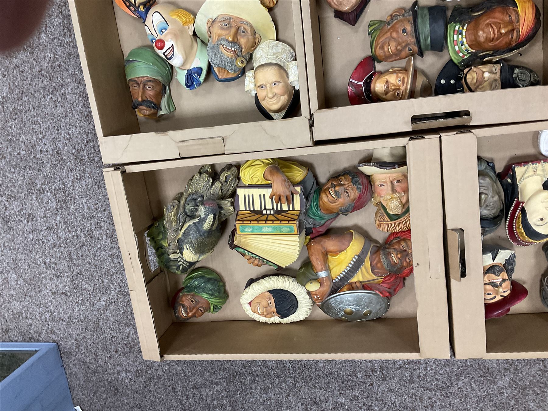 Large collection of Bossons plaster wall-masks, including including fisher man, policeman, highway man, etc, in four boxes 