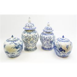 Two Chinese blue and white urns and covers, largest H45cm, together with a pair of Chinese blue and white ginger jars and covers, H25cm. 