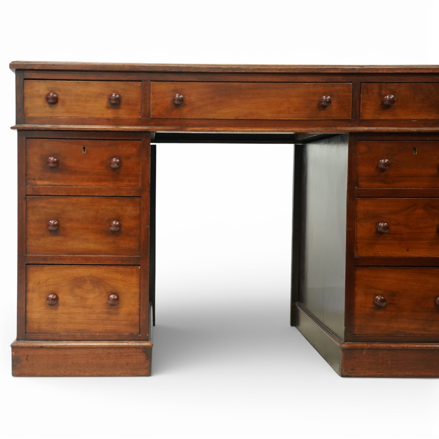 Victorian mahogany pedestal desk, rectangular moulded top inset with green leather writing surface with gilt tooling, fitted with three frieze drawers above opposing pedestals each fitted with three drawers, all with turned wooden knob handles, plinth bases