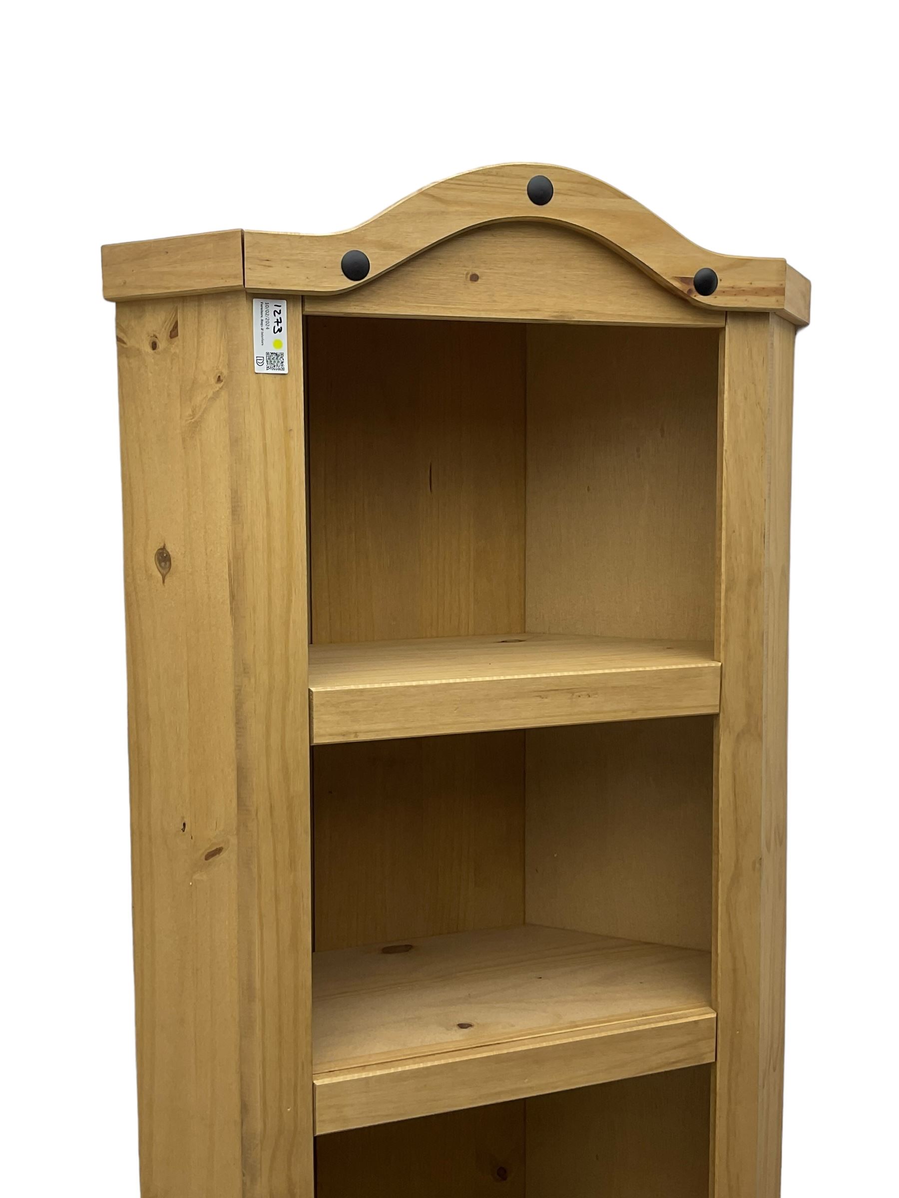 Pine media or television cabinet, enclosed by single glazed door (W56cm, H82cm, D43cm); pine corner cupboard, three shelves over single cupboard (W76cm, H188cm); pine two-tier plate rack with shaped frieze and uprights (W113cm, H107cm)