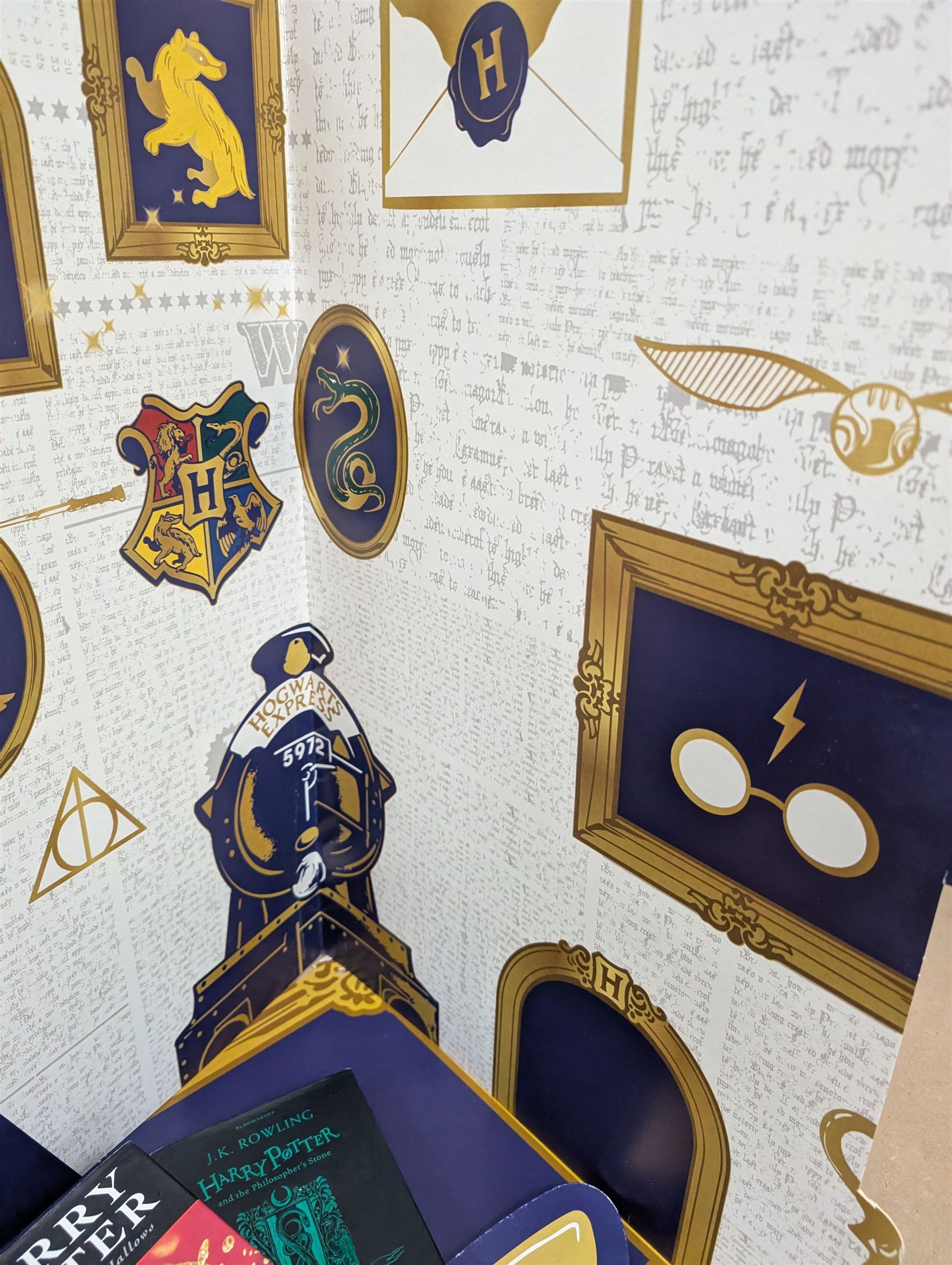 Eleven JK Rowling books, comprising six Harry Potter books, including four first editions, Fantastic Beasts screen play, Harry Potter and the Cursed Child, Tales of Beedle the Bard, Casual Vacancy first edition, Christmas Pig First edition and a Harry Potter card board back drop