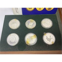 The Royal Mint 'Conservation Coin Collection' formed of twenty-four silver proof coins, housed in the wooden display case, with information booklet