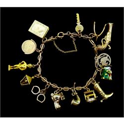 9ct gold link bracelet, with eleven 9ct gold charms including Toby jug, shoe house and 'Good Luck' swivel, 14ct gold statue charm and two gilt boot and pipe charms