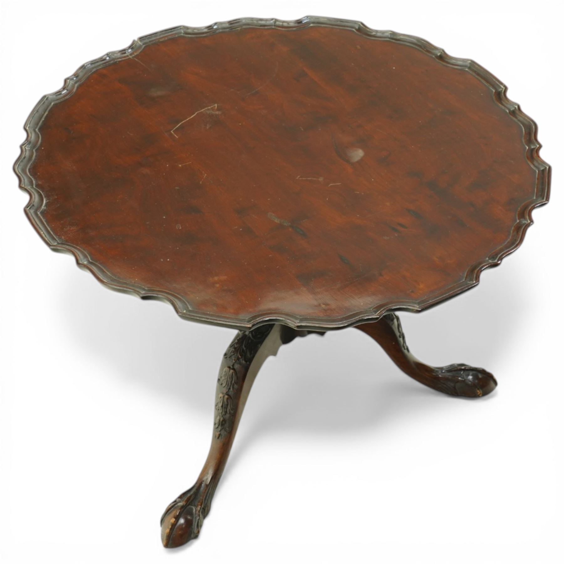 Late 19th century mahogany piecrust occasional table, circular top with scalloped moulded edge, on a turned pedestal with carved cabriole supports terminating in claw and ball feet