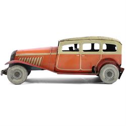 Mettoy tinplate clockwork Citroen saloon car, red orange body with cream roof and windows, with driver, Dunlop tyres and key, H9cm, L26cm