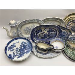 A large group of 19th century and later transfer printed pottery, mostly blue and white, to include a footed dish decorated in the Long Bridge pattern, four Asiatic Pheasant pattern platters, Athens pattern creamer, various plates decorated in Oriental and Willow type patterns, a Copeland & Garrett plate decorated in a view from the Continental View series, a Madras pattern tureen stand, etc. 