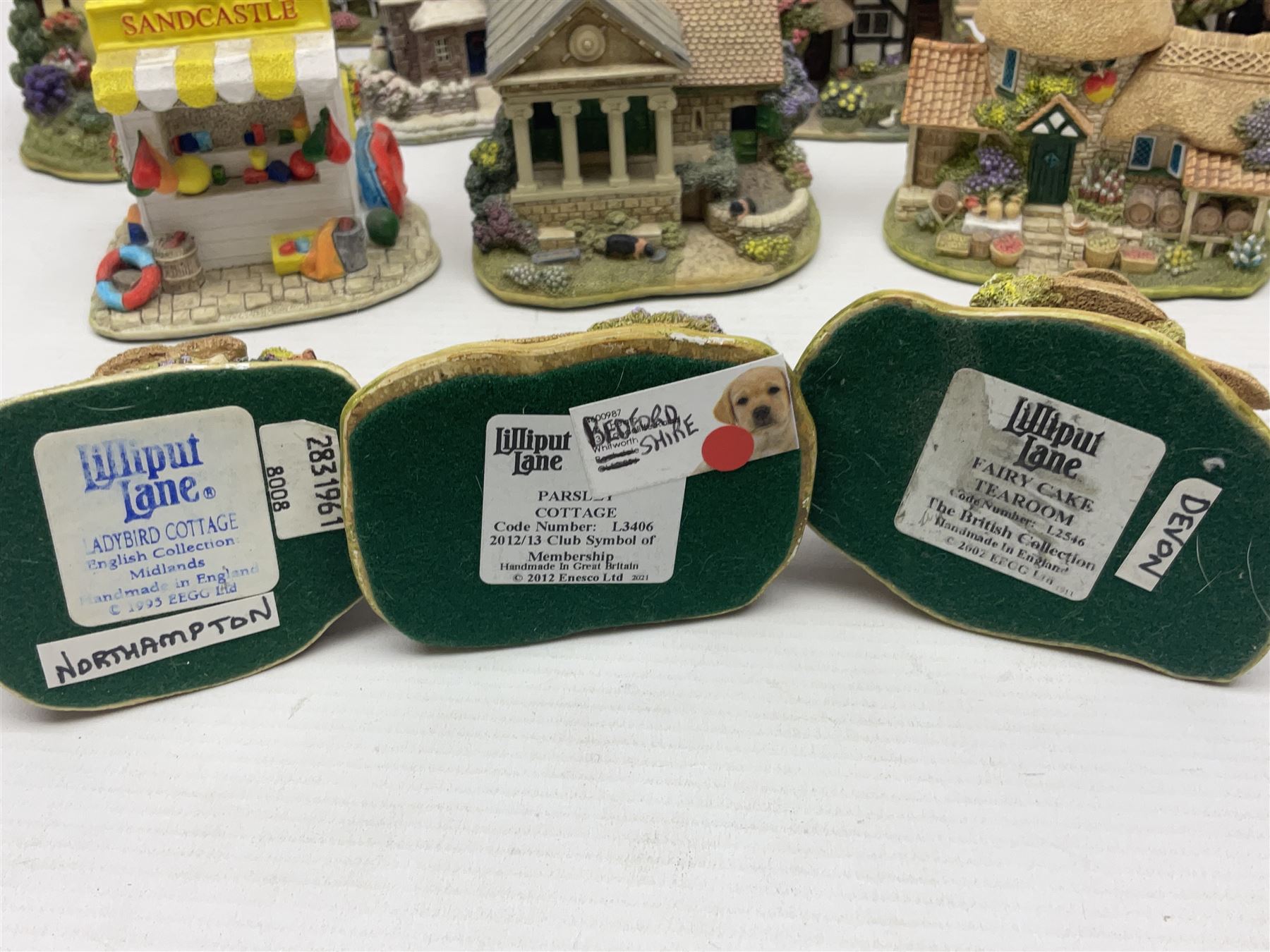 Eighteen Lilliput Lanes, including The Penny Farthing, The Pigsty, Borrowdale School, Fairy Cake Tearoom, An Apple a Day,Ladybird Cottage etc, all with original boxes 