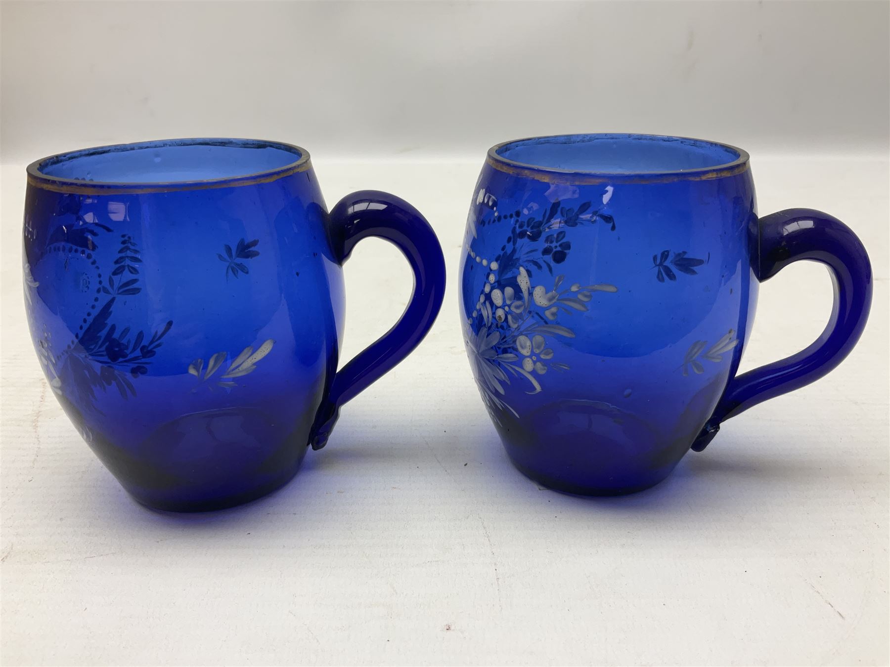 Pair of Victorian cobalt blue glass cups with gilt and painted decoration, entitled Hope's the Balm of Life and Love me as I Love Thee, H8.5cm