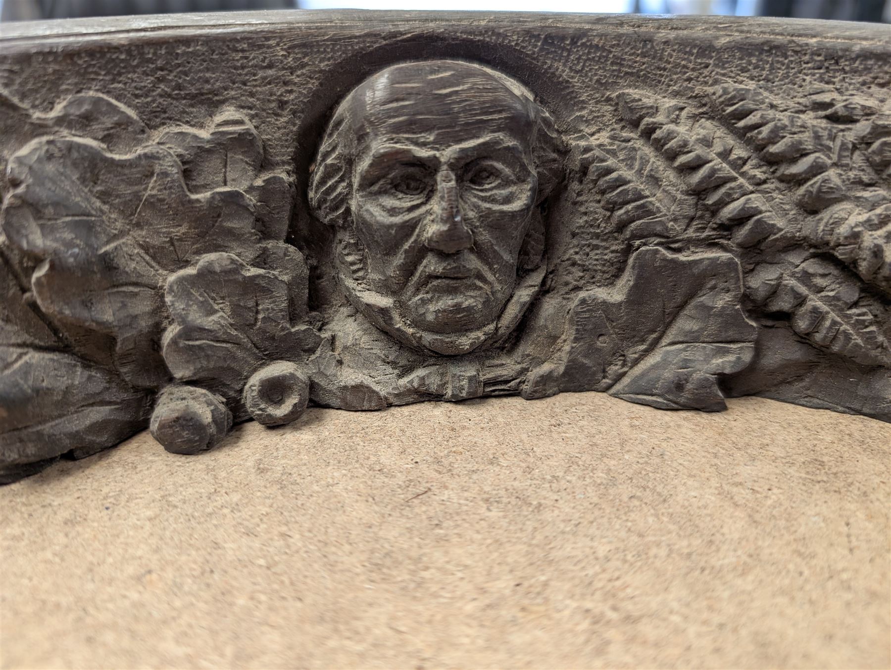 Military issue 02A gimbal compass, with broad arrow mark, together with a brass porthole and a piece of wood carved with portrait and foliage