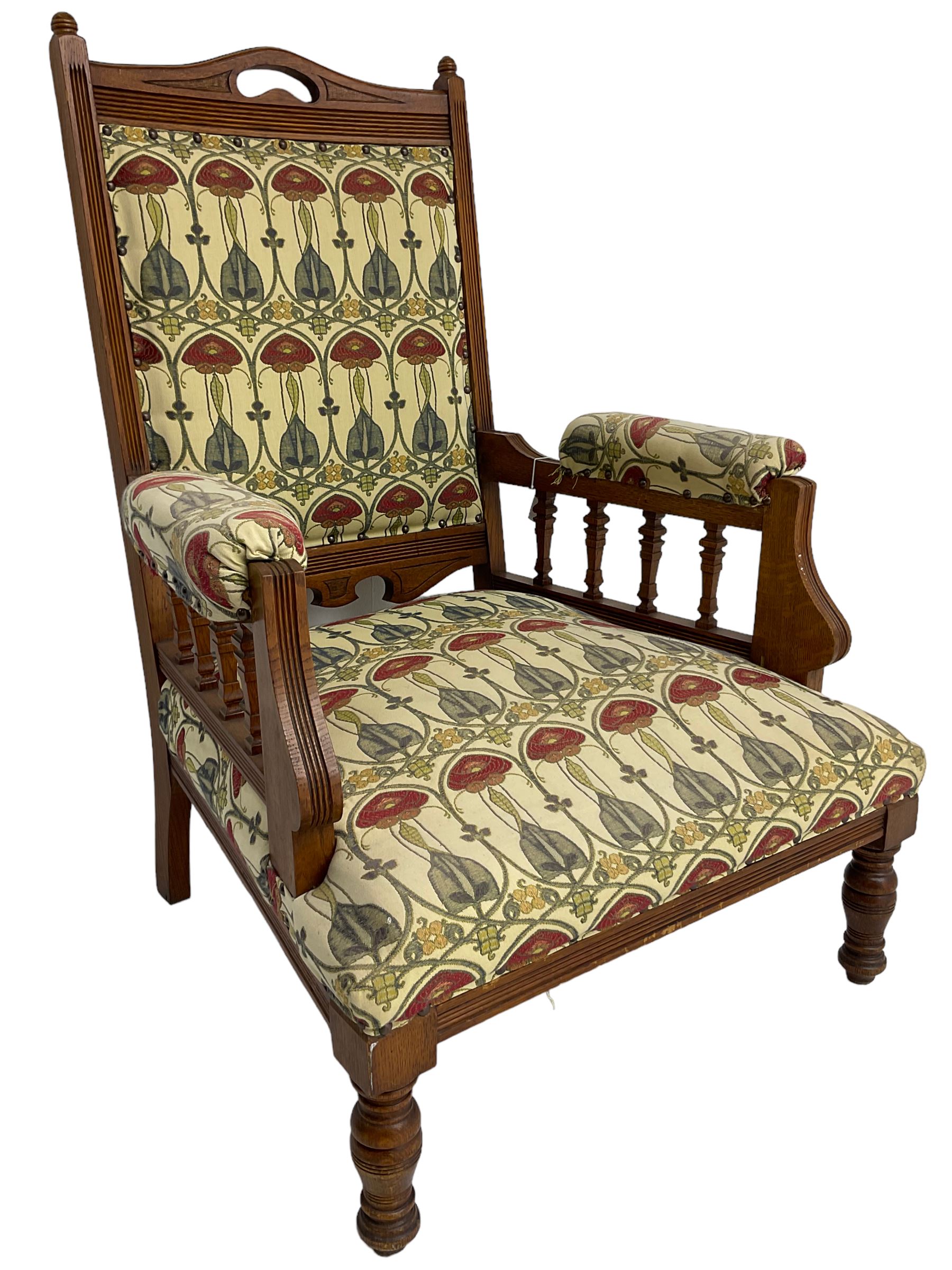 Early 20th century armchair, back and sprung seat upholstered in Art Nouveau patterned fabric, raised on ring turned supports, the frame with all-over reeded decoration