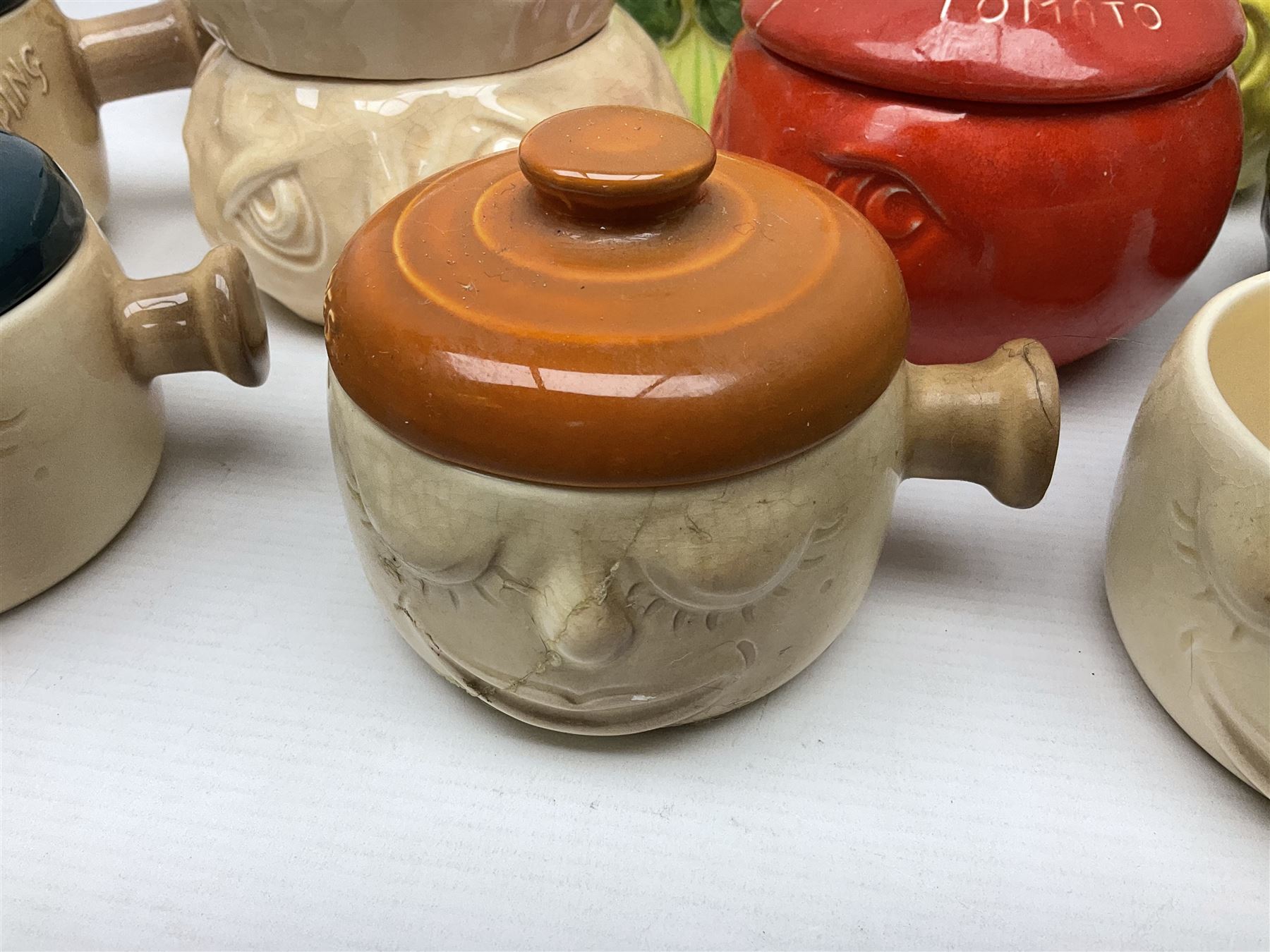 Collection of mostly Sylvac kitchen storage jar face pots, including piccalilli, chutney, tomato and bread sauce, tallest H15.5cm
