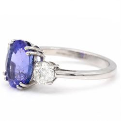 Platinum tanzanite and diamond three stone ring, single oval cut tanzanite of approx 3.55 carat, with a round brilliant cut diamond set either side, total diamond weight approx 0.80 carat