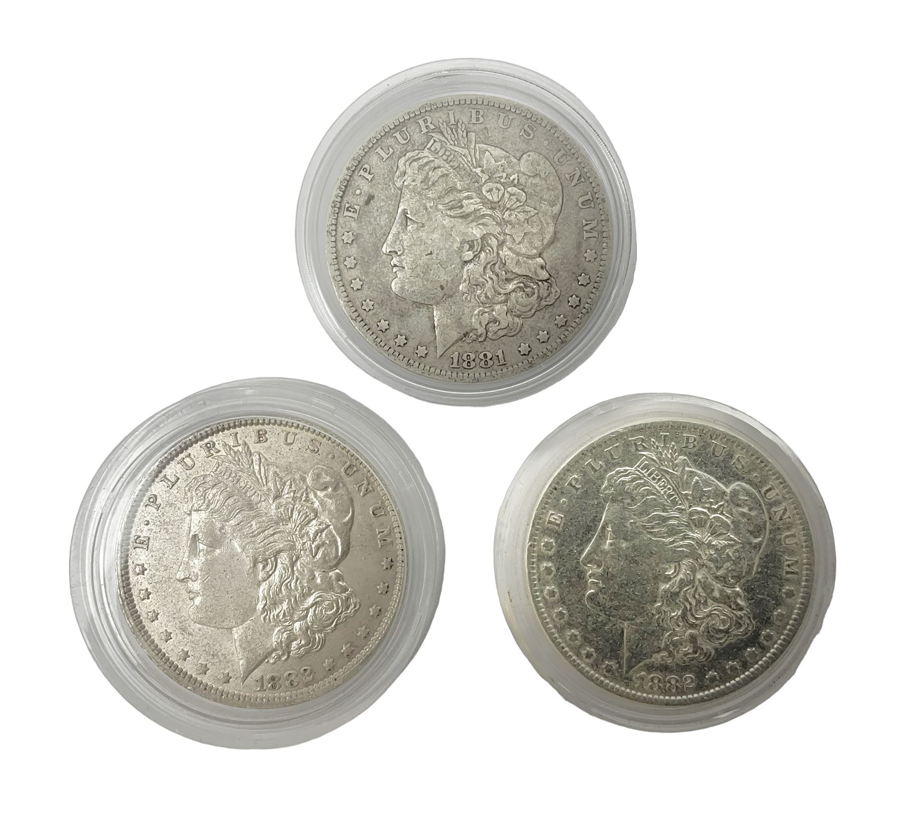 Three United States of America silver Morgan dollar coins dated 1881 O, 1882 and 1882 O