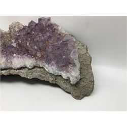Amethyst crystal geode cluster, with well-defined crystals of various sizes, H13cm, L46cm