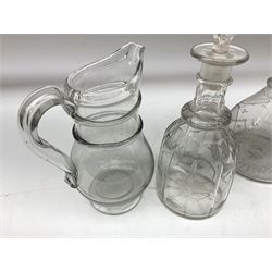 19th century clear glass jug with double ring neck and swan neck handle, together with four 19th century clear glass decanters to include etched examples with triple ring necks, cut examples etc