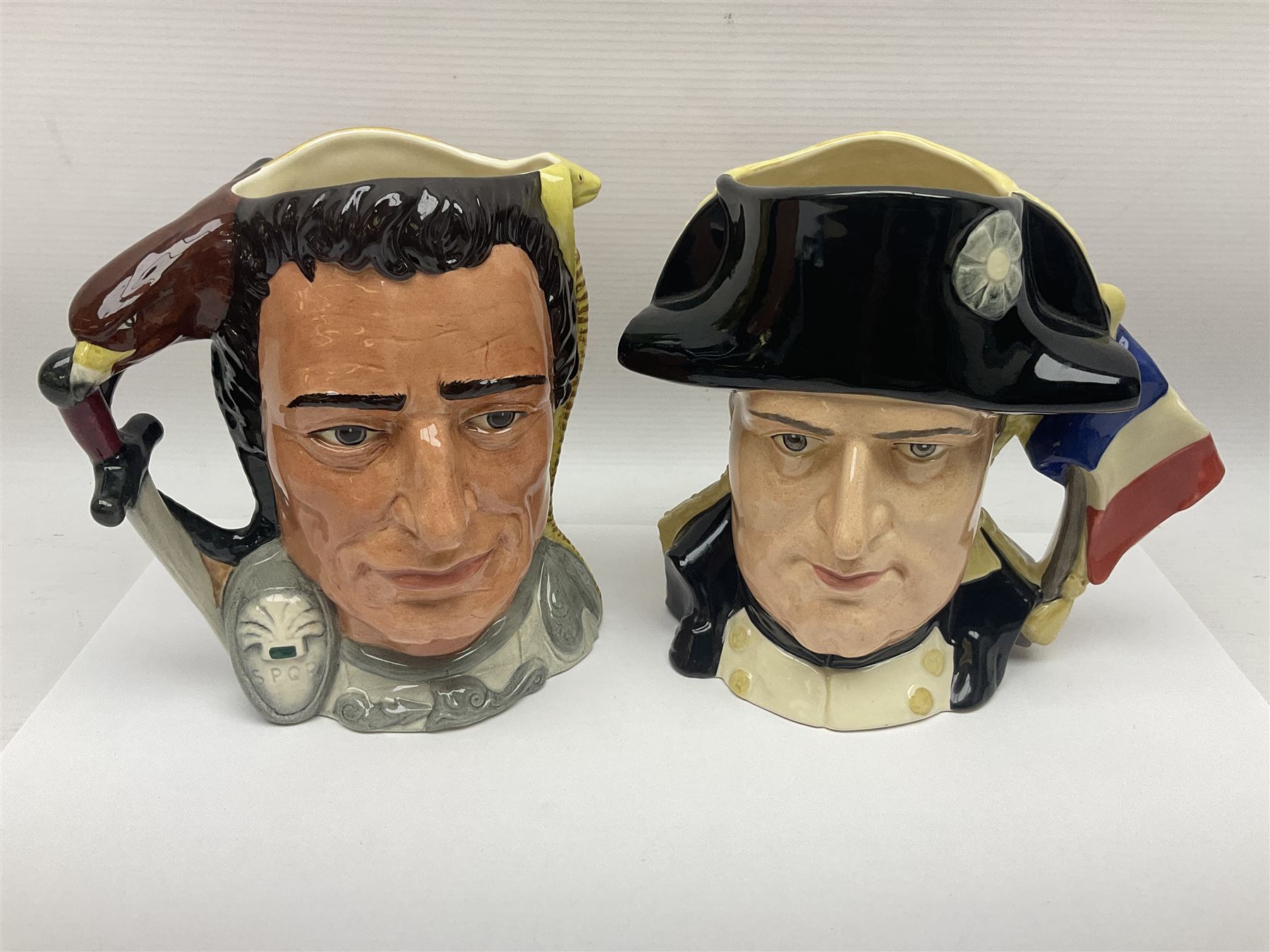 Royal Doulton two character jugs from the Star Crossed Lovers Collection, Antony & Cleopatra D6728 and Napoleon & Josephine D6750, together with two Royal Doulton Figures Micawber and Sairey Gamp