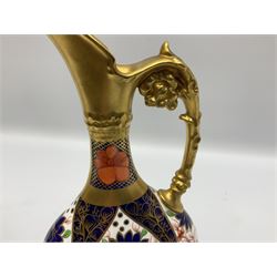 Pair of mid 20th century Royal Crown Derby Imari 1128 pattern Kedleston ewers, each with gilt scroll handle and neck, upon a gilt quatrefoil foot, each with printed marks beneath, H25.5cm