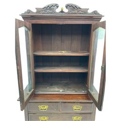 Late Victorian cabinet on chest, shaped and carved pediment over two glazed doors, the chest fitted with two short and two long drawers