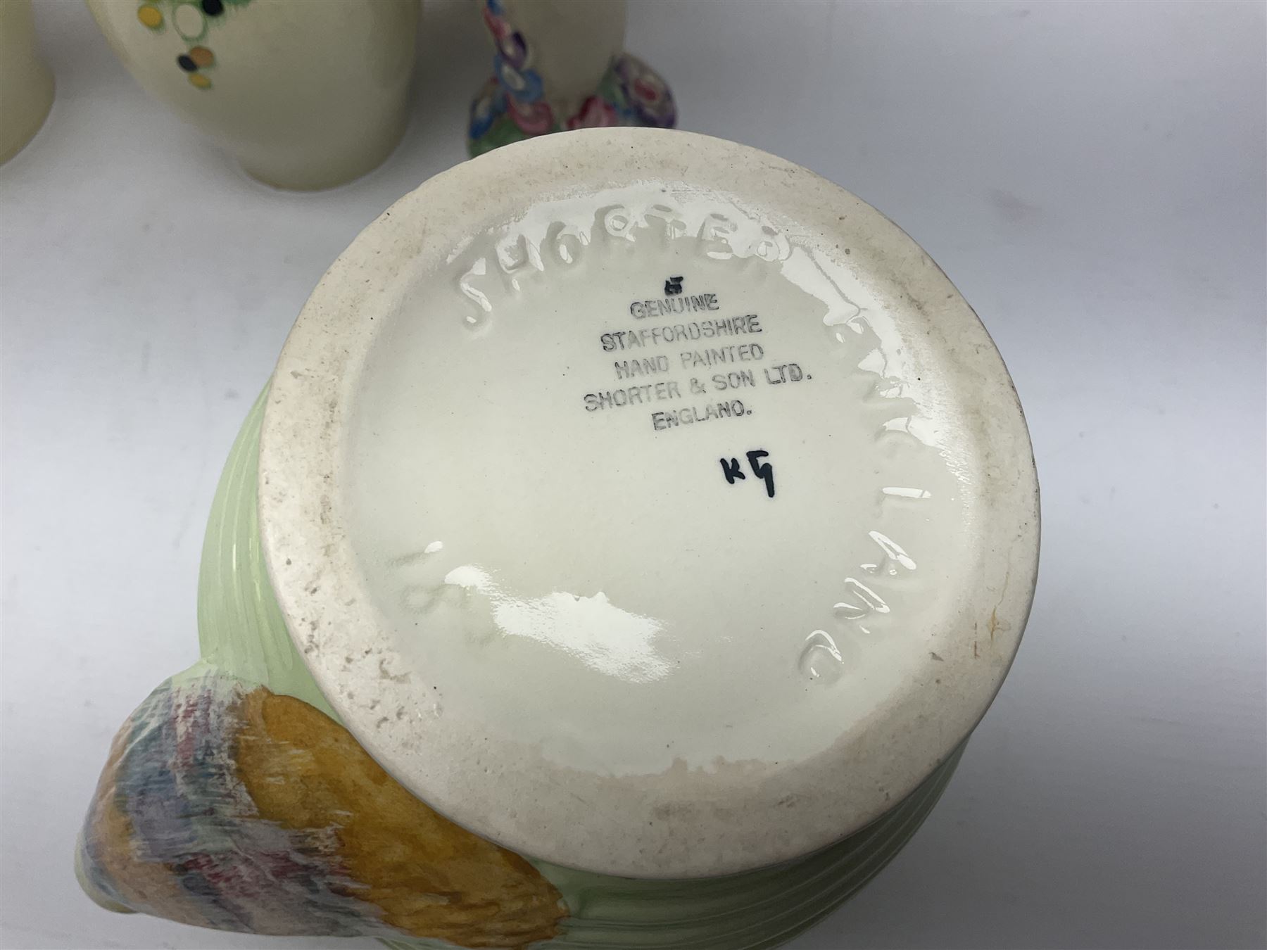 Collection of 1930s ceramics, comprising Shorter & Son jug with bird handle, set of three J.H.W & Sons graduating jugs, Clarice Cliff My Garden pattern vase and Celtic Harvest pattern cake plate and a Burleigh Ware sandwich plate set, bird jug H21cm