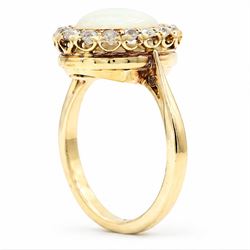 Early 20th century gold opal and diamond cluster ring, single oval cabochon opal, surrounded by sixteen old cut diamonds, stamped 18ct, total diamond weight approx 0.65 carat