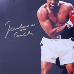 Large colour print depicting the famous scene of boxer Muhammad Ali standing over the defeated Sonny Liston, taken from their 1964 rematch, signed by Ali to the left middle in gold marker, with his double signature 'Muhammad Ali AKA Cassius Clay', with certificate of authenticity from Fraser's Autographs, framed, picture H49cm