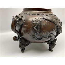 Japanese bronzed koro, the body of globular form with twin cast zoomorphic mask handles, decorated in relief with birds upon blossoming branches, against a ground incised with rushes and peonies, the flat toped domed cover with pierced band and surmounted by a cast figure of a Foo dog, the whole upon three zoomorphic mask feet, with impressed character type mark beneath, H35.5cm
