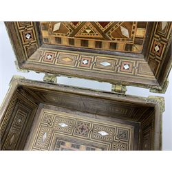 Late 19th century Damascus Cairoware Quran box, of square form with canted hinged cover, upon four circular pad feet, the brass exterior inlaid with silver and copper script and decorative detail, opening to reveal a marquetry lined interior, H15.5cm W19cm D19cm