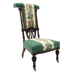 Victorian mahogany prie dieu chair, the carved frame with floral and swag decoration, on fluted and turned supports with brass and ceramic casters, upholstered in green floral needlework fabric 