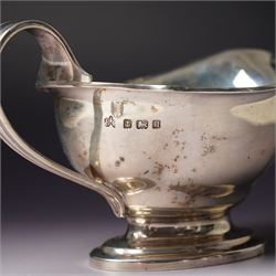 Victorian silver sauce boat engraved with a monogram Sheffield 1892 Maker John Round  & Son Ltd, another with crimped rim Birmingham 1912 Maker Elkington & Co, two silver pepperettes and a small silver challenge cup
