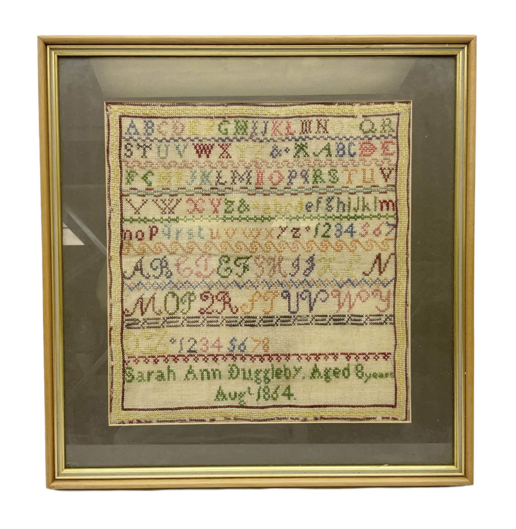 Victorian sampler, worked by Sarah Ann Duggleby, dated August 1864, depicting lines of alphabet, framed and glazed, by vendor repute Beswick Hall provenance, overall H46cm L43cm