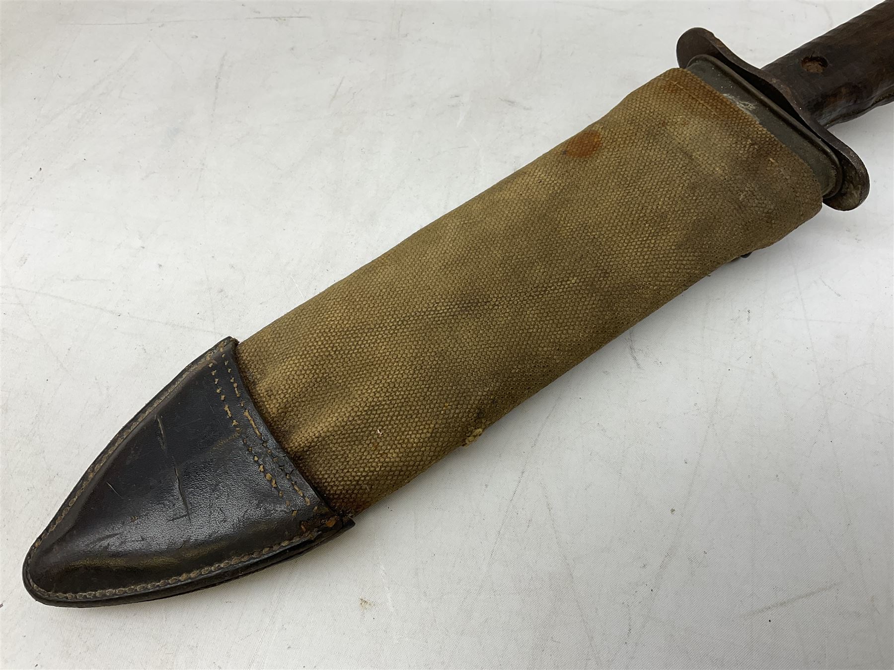 US Model 1910/17  Machine Gunners Bolo knife, the 26.5cm curving steel blade marked 'US MOD 1917 PLUME PHILA 1918'; in webbing covered steel scabbard with leather chape marked 'Brauer Bros 1918' L40.5cm overall (with photocopy of modern reference material)